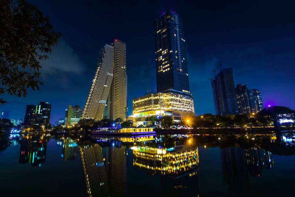 Stunning night view of Colombo's modern skyline reflected in calm waters.